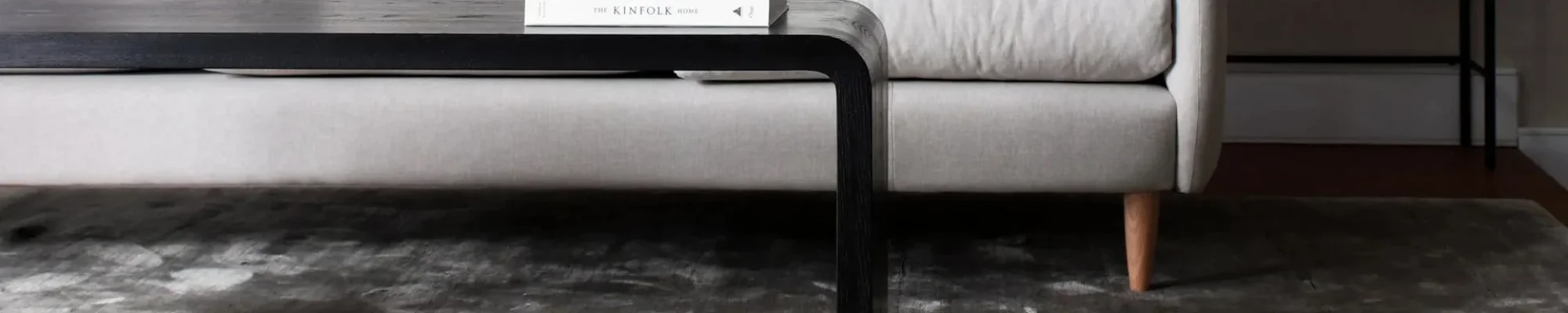 white couch and black coffee table on a gray carpet floor from Apollo Flooring Center in Tuscon, AZ